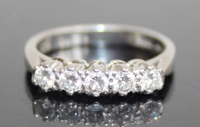 Lot 2792 - A platinum diamond half hoop ring, arranged as...