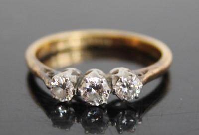 Lot 2816 - An 18ct gold and platinum diamond trilogy ring,...