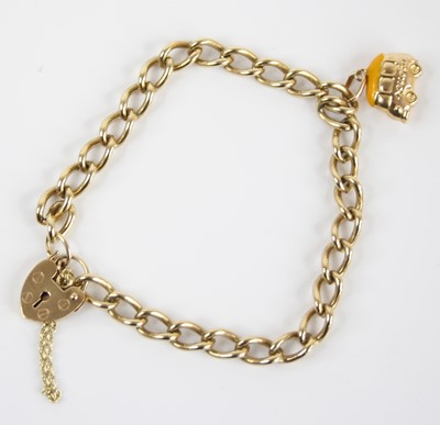 Lot 2464 - A 9ct gold curblink bracelet, with heart...