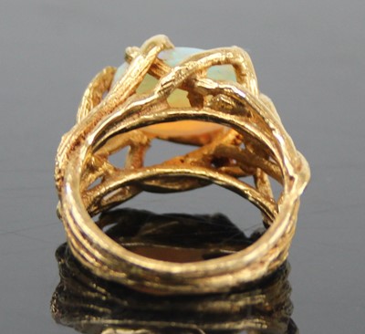 Lot 2459 - An 18ct gold and cabochon opal set dress ring,...