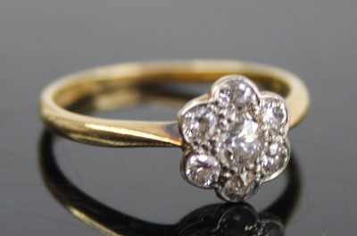 Lot 2458 - An 18ct gold and platinum diamond flower head...
