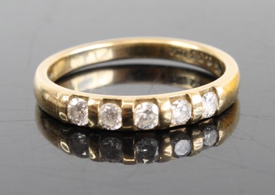 Lot 2796 - A 9ct gold diamond half eternity ring arranged...