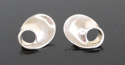 Lot 2494 - A pair of silver ear studs designed by...