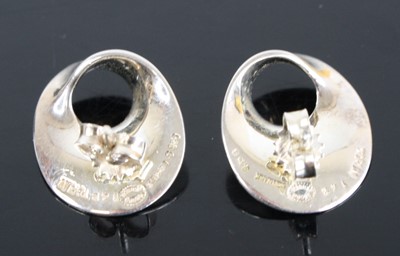 Lot 2494 - A pair of silver ear studs designed by...