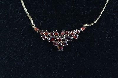 Lot 2878 - A modern 9ct gold garnet set necklet, the...