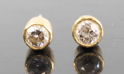 Lot 2884 - A pair of yellow metal diamond ear studs, the...