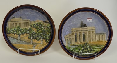 Lot 4 - A pair of German pottery wall plates, each...