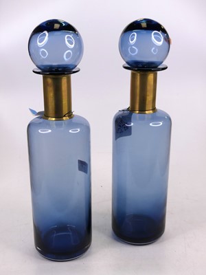 Lot 17 - A pair of blue glass bottles, each having a...