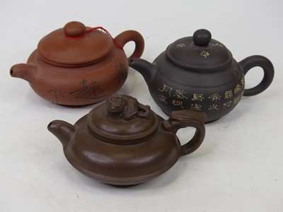 Lot 44 - Three Chinese Yixing type teapots, the largest...