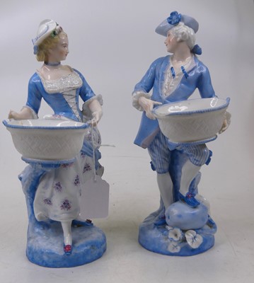 Lot 64 - A pair of porcelain figures of a gentleman and...