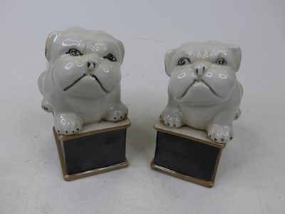 Lot 68 - A pair of porcelain figures of bulldogs, each...