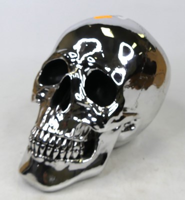 Lot 70 - A silver painted composite model of a skull