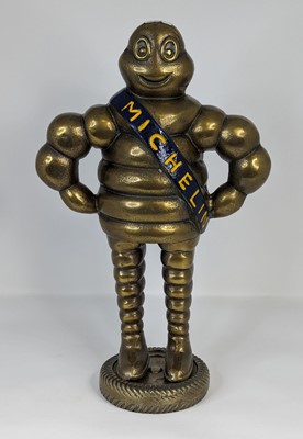 Lot 130 - A reproduction brass figure of the Michelin...