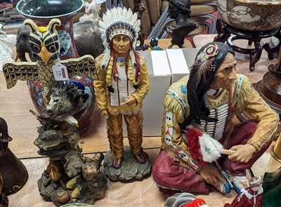 Lot 135 - A modern resin figure of a native American man,...