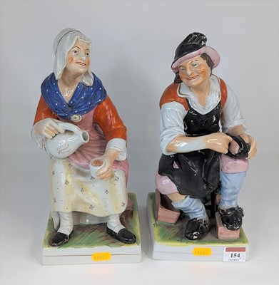 Lot 154 - A pair of Staffordshire pottery figures of...