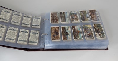 Lot 160 - An album containing 18 full sets of cigarette...