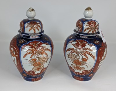 Lot 198 - A pair of Japanese Imari jars and covers, each...