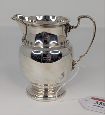 Lot 359 - A George V silver milk jug of baluster form,...