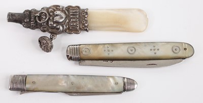 Lot 389 - A white metal and mother of pearl teething...