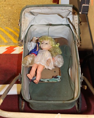 Lot 1542 - A vintage child's pram with a quantity of...