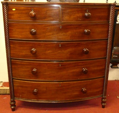 Lot 1167 - A Regency mahogany bowfront chest, of two...