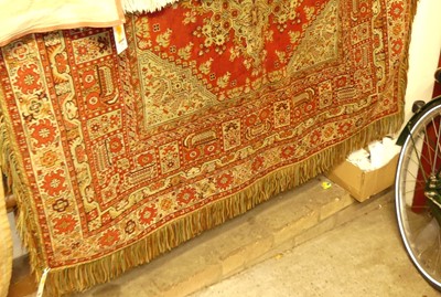 Lot 1183 - An Afghan red ground woollen table covering,...