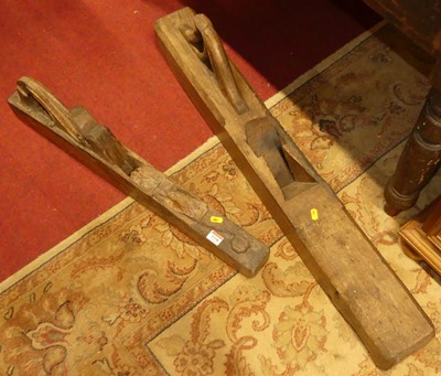 Lot 1258 - Two rustic long woodworking planes, the larger...