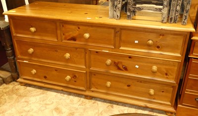 Lot 1262 - A modern pine long side chest, fitted with an...