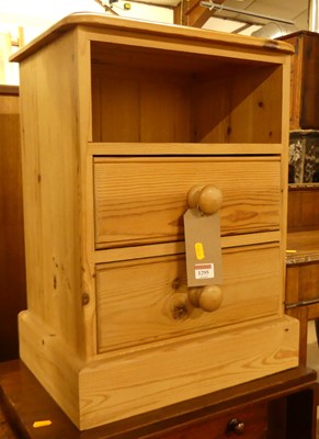 Lot 1295 - A modern pine two drawer bedside chest, with...