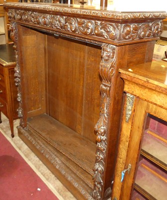 Lot 1299 - A circa 1900 heavily carved oak freestanding...