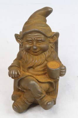 Lot 530 - A rusted metal model of a gnome seated in a...