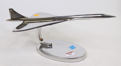 Lot 553 - A polished metal desk ornament in the form of...