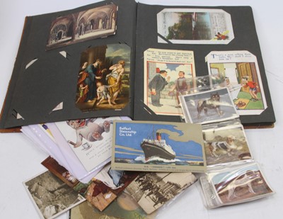 Lot 565 - An early 20th century postcard album...