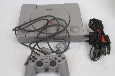 Lot 567 - A Sony Playstation console, with controller,...