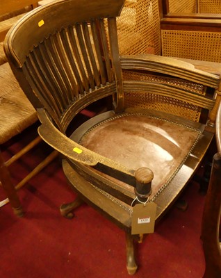 Lot 1330 - A 1930s oak slat back tub swivel desk chair,...