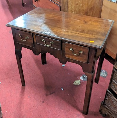 Lot 1358 - A George III mahogany three drawer lowboy,...