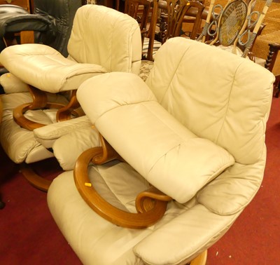 Lot 1334 - A pair of Stressless cream leather reclining...