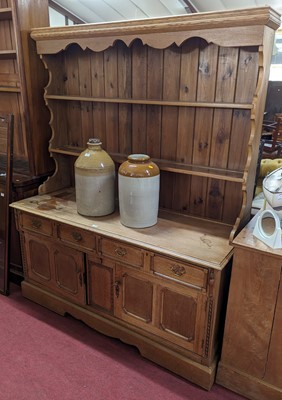 Lot 1370 - A light oak dresser, having two-tier open...