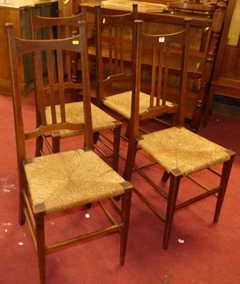 Lot 1342 - A set of four Arts & Crafts oak slat back rush...