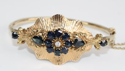 Lot 2271 - A yellow metal, sapphire and diamond hinged...