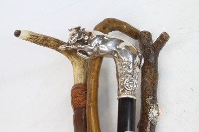 Lot 579 - An ebonised walking stick, the filled silver...