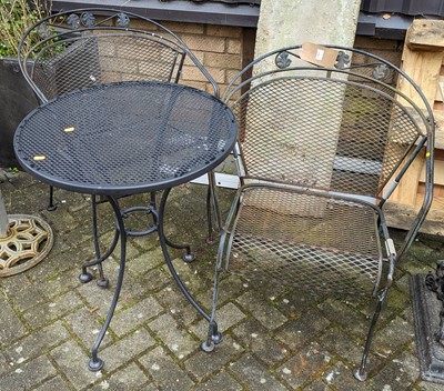 Lot 1384 - A black-painted wired metal circular patio...