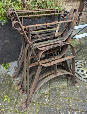 Lot 1385 - Five pairs of cast iron bench ends, each...