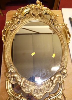 Lot 1158 - A gilt composition oval wall mirror, 20th...