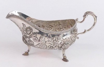 Lot 2180 - An Edwardian silver sauceboat, repousse...