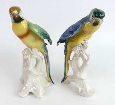 Lot 32 - Karl Ens - a pair of porcelain perched parrots,...