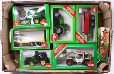 Lot 2130 - A Siku 1/32 scale boxed group of seven...