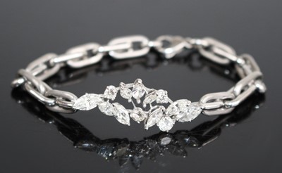 Lot 2265 - A white metal diamond bracelet, comprising a...