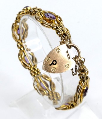 Lot 2232 - A 9ct gold and amethyst set gatelink bracelet,...