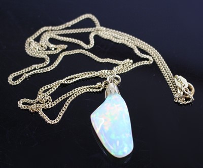 Lot 2241 - A polished opal pendant, of natural form,...